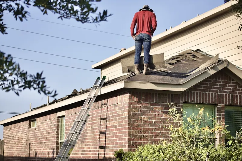 Professional roofer working on a residential roof in Maple Meade